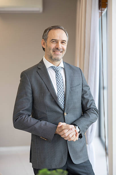 Businessman Standing by the Window