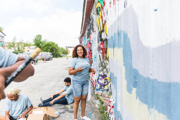istock Volunteers Painting a Graffiti-Covered Wall in Texas 2203823014