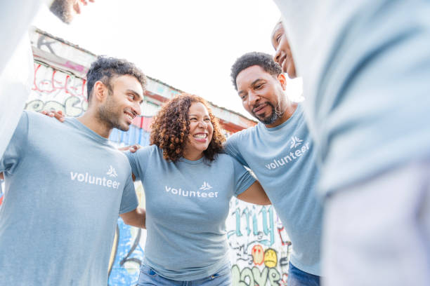 istock Multiracial Group of Volunteers Hugging, Smiling Together 2203823040