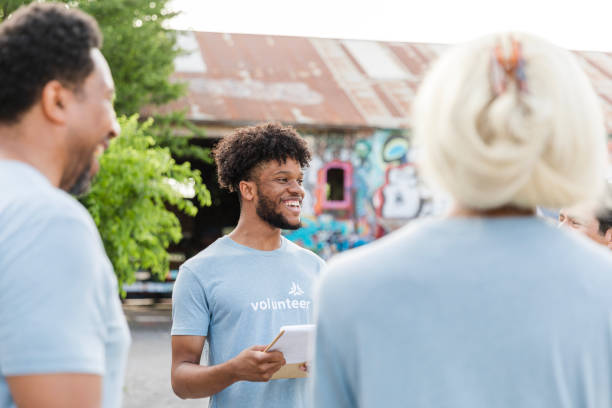 istock Smiling Volunteer Reporting Back to Team After Community Outreach 2203823055