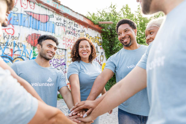 istock Multiracial Group of Volunteers Stacking Hands, Teamwork 2203823071