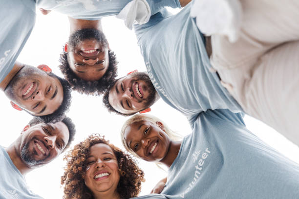 istock Happy Diverse Group of Volunteers Hugging Together 2203823126