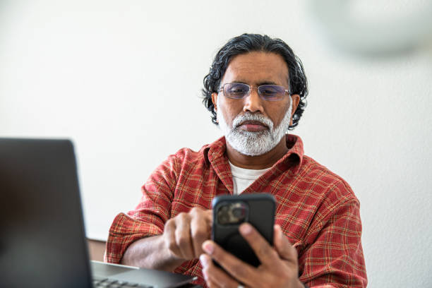 istock Mature Indian Man Working from Home Office at Laptop 2203824039