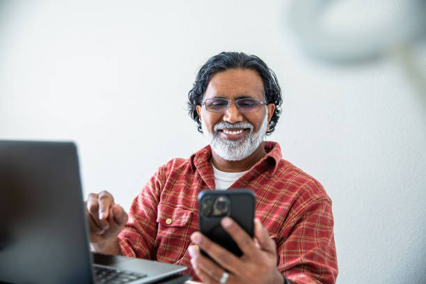 istock Mature Indian Man Working from Home Office at Laptop 2203824040