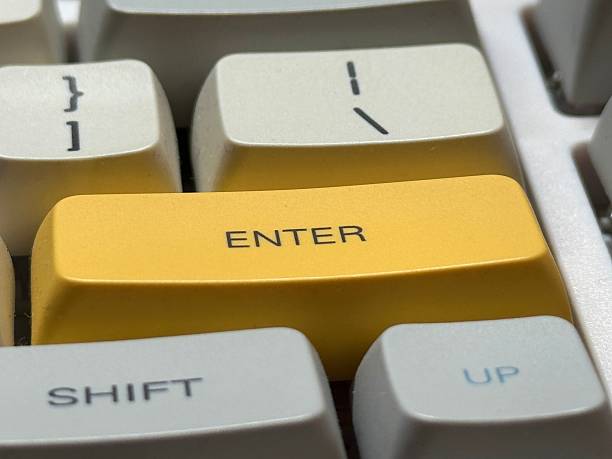 istock White mechanical keyboard in the office with big yellow Enter button 2203826285