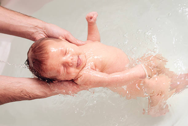 istock A newborn baby is bathing in the bathtub. 2203831264