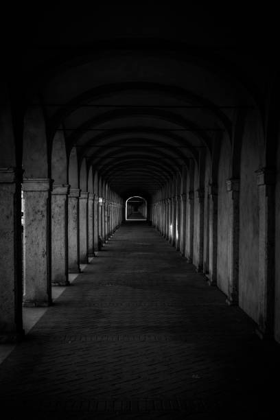 istock Dark tunnel perspective. Grunge architecture, old corridor in shadow. 2203833782