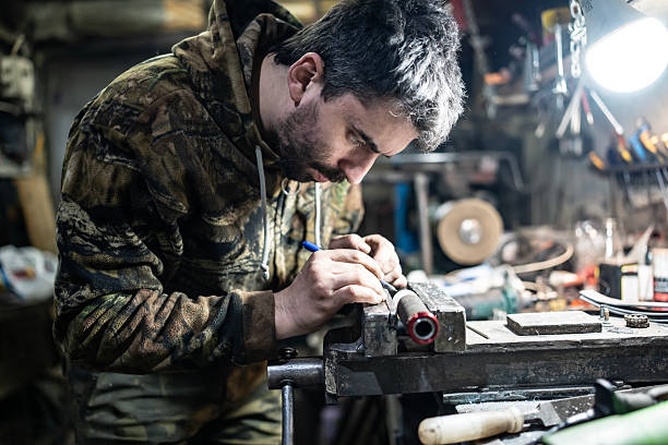 istock Man Focusing on Working in a Workshop with Precision and Detail 2203834061