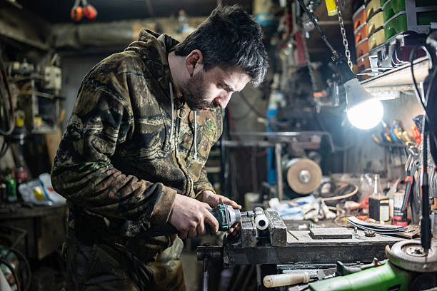 Mechanical Craftsman Working in Workshop with Power Tool and Detailed Focus