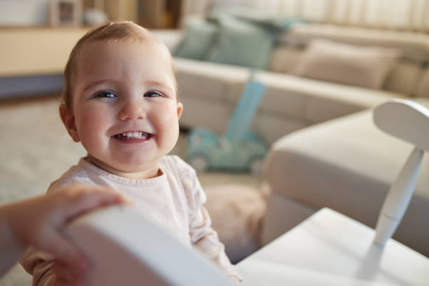 Baby girl playing in domestic room.