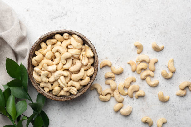 istock Dry cashew nuts on grey stone background 2203840574