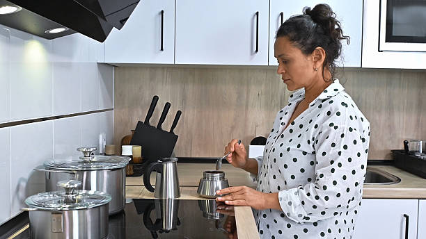 istock Woman Preparing Coffee in Modern Kitchen 2203842591