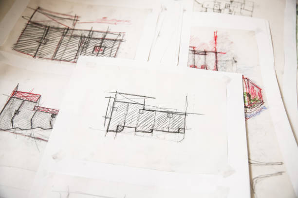 istock Top view of architect plan drawings and sketches during the creative process of the architecture project 2203843781