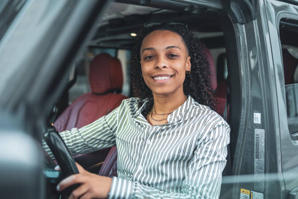 istock Smiling Woman Driving a Modern Vehicle for a Positive Journey Experience 2203844631