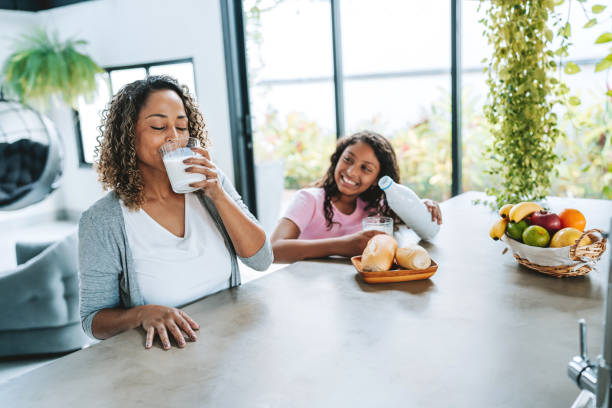 istock Mother and daughter drinking milk together 2203845514