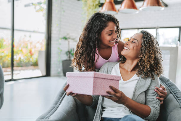 istock Daughter presents a gift to her mother 2203845593