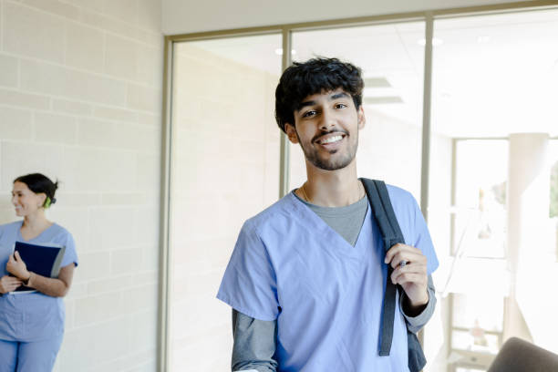 istock Smiling Medical Student in Scrubs with Backpack 2203846275