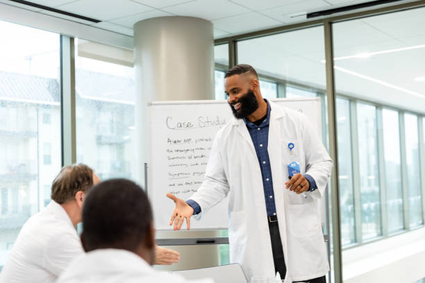 istock African-American doctor explaining case study to colleagues 2203851029