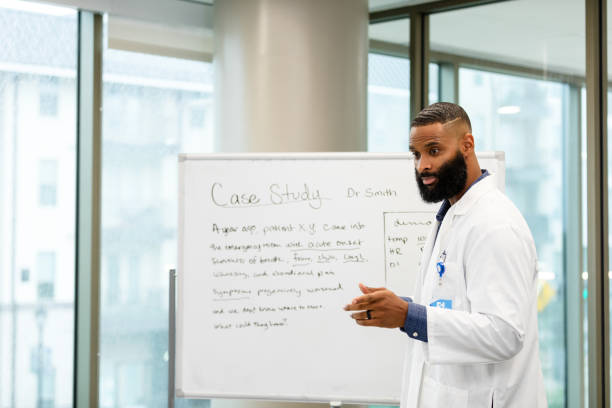 istock Male Doctor Explains Medical Case Study to Students 2203851050