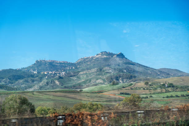 Catania, Italy - November 3, 2024: Scenic mountain view from highway with clear blue sky in rural landscape, editorial image