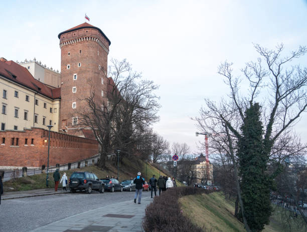 Warsaw, Poland, January 27, 2025: Wawel Castle in Krakow, Poland, medieval brick tower and a cobblestone walkway, historical architecture, tourism, cultural heritage, editorial image