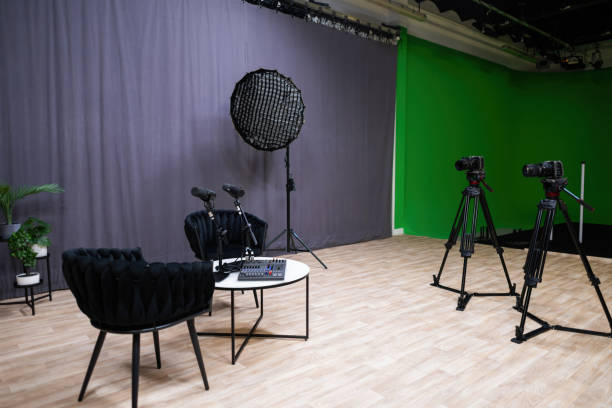 istock Podcast studio setup with microphones, cameras, and green screen 2203861452