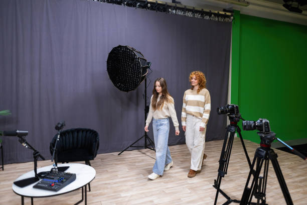 istock Podcasters walking in professional recording studio with green screen 2203861475