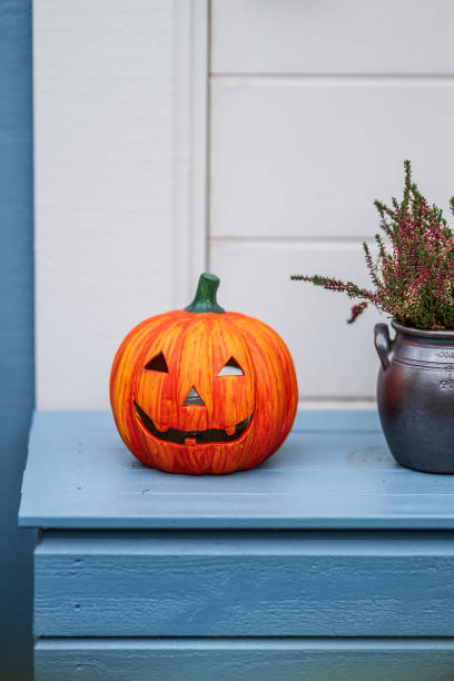 istock Halloween pumpkin decoration on a blue table.. 2203867589