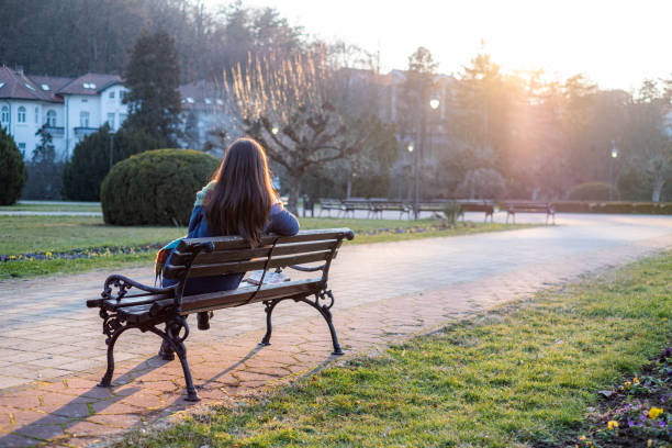portrait of a woman sitting on a bench and enjoying the view
