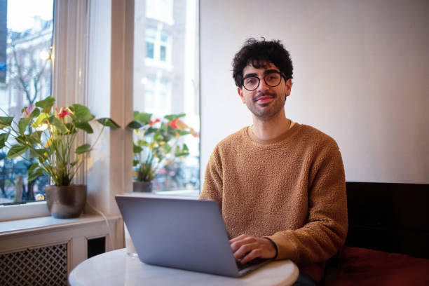 istock Young Professional Working on a Laptop in a Cozy Indoor Setting 2203869442