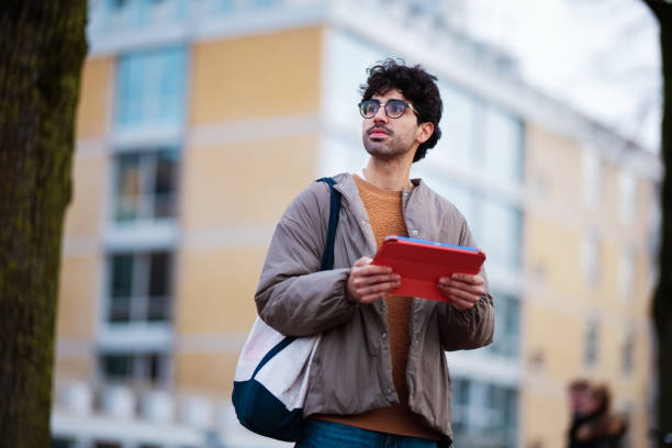 istock Young Professional Holding Tablet Outdoors in Urban Environment 2203869475