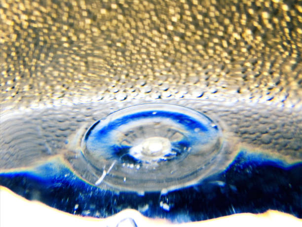 The bottom of a plastic bottle containing liquid detergent in close-up
