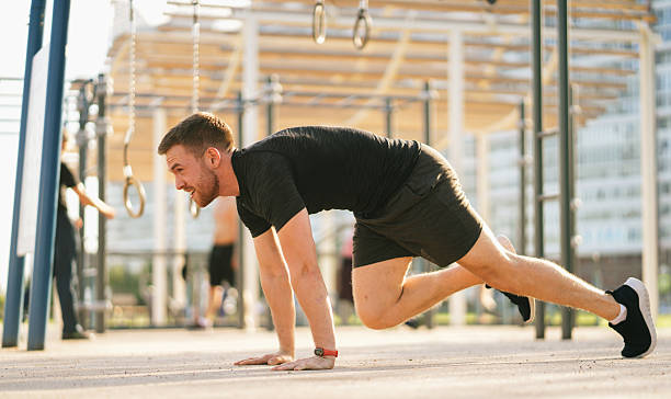 istock An athlete engages in intense mountain climbers, showcasing energy and dedication on a sunlit park path. 2203889332