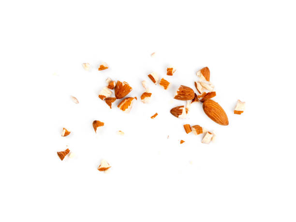 Crushed almonds isolated, nut pieces, sliced scattered almond seeds and cut kernels collection on white background