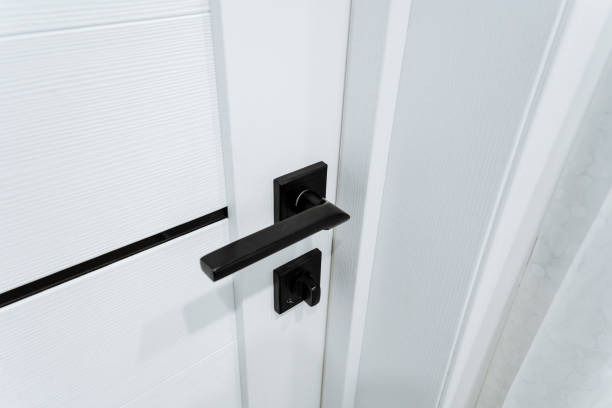 istock Here is a detailed close up of a white door featuring a black handle 2203892479