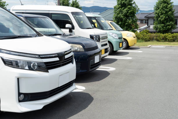 istock Cars lined up in a parking lot 2203893057