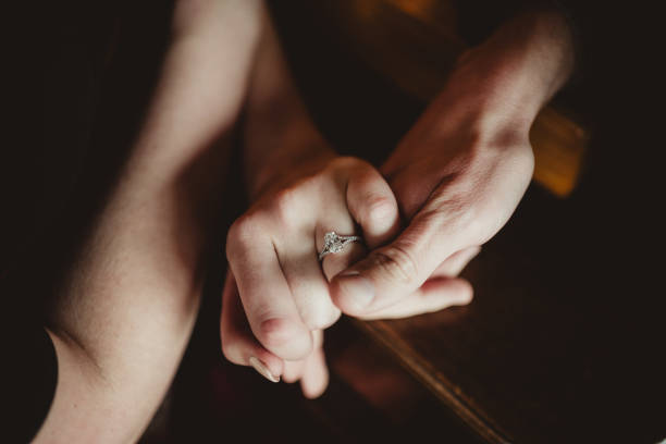 picture of man and woman with wedding ring, newlyweds choose and buy a wedding ring in a jewelry store