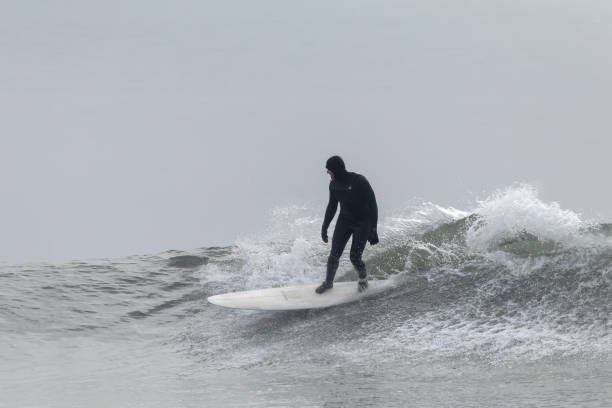 Tampico, Tamaulipas Mexico, January 04 2023 young man surfing the waves in the gulf of mexico, at miramar beach in tampico madero tamaulipas