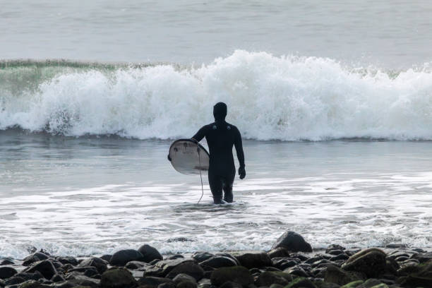 Jordan River, British Columbia, Canada - March 2, 2025: Surfers catching some waves at this popular location, along the shores of western Vancouver Island.
