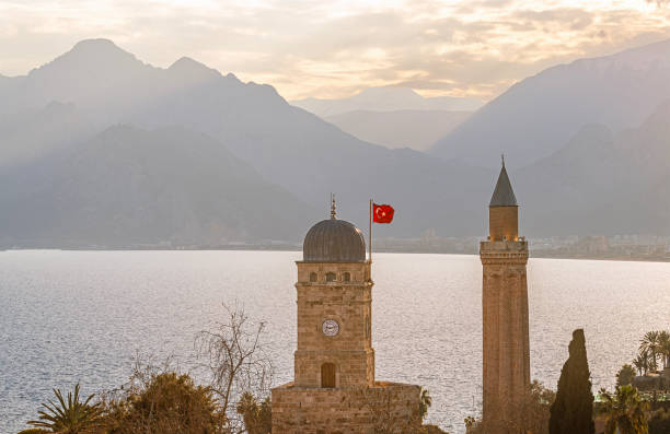 elevated view of cityscape image of historic district of Antalya over Mediterranean sea and high mountains with clear blue sky in Turkey