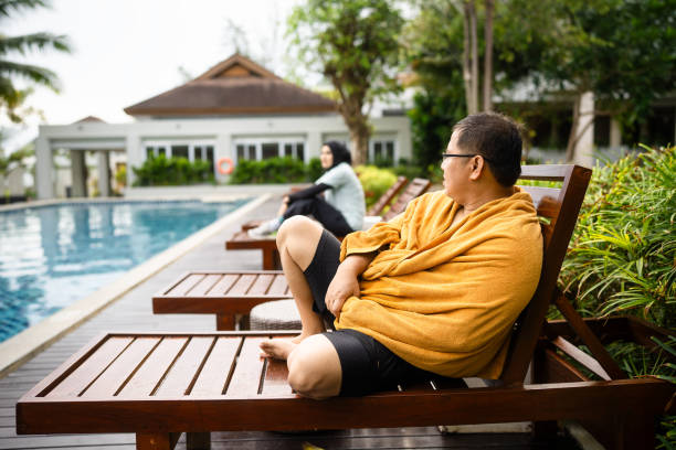 man sitting in swimming pool in the morning