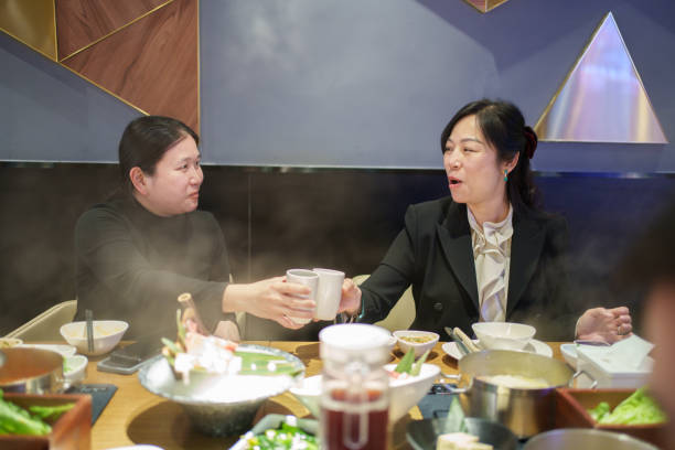 istock Two Asian women toasting 2203909267