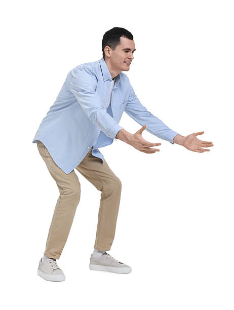 istock Young man in light blue shirt and beige pants on white background 2203910460