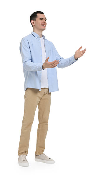 istock Young man in light blue shirt and beige pants on white background 2203910468