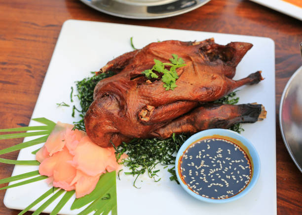 istock Roast Duck on wood table background. Crispy whole duck, Grilled Peking Duck. 2203911770
