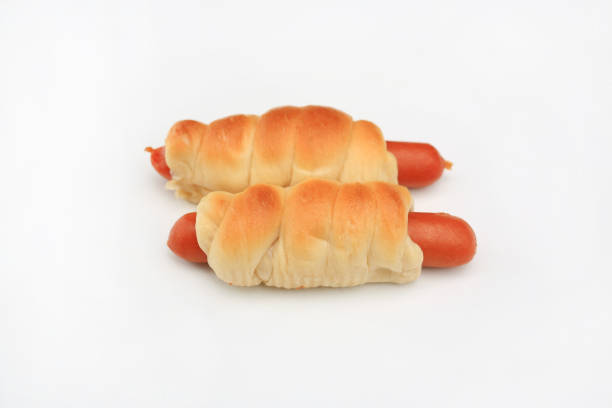 Twisted baked bun with sausage inside isolated on white background.
