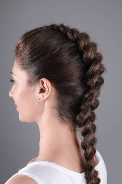 istock Woman with braided hair on grey background 2203912074