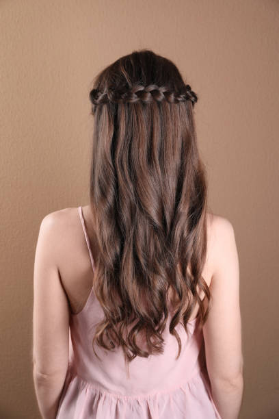 istock Woman with braided hair on light brown background, back view 2203912076