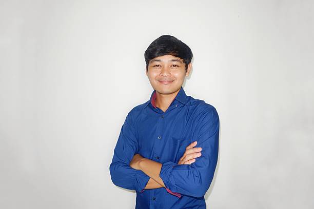istock an Indonesian man is taking a selfie with a random expression and style then blue shirt, self potrait 2203912649