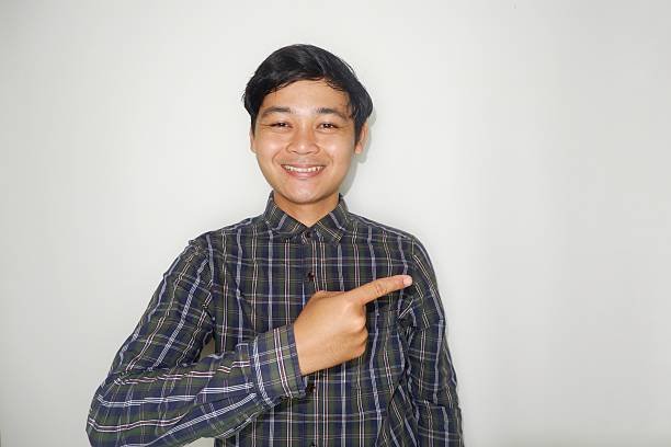 istock an Indonesian man is taking a selfie with a random expression and style and green shirt, self potrait 2203913266